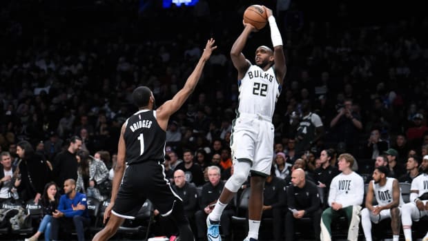 Milwaukee Bucks forward Khris Middleton (22) shoots the ball against Brooklyn Nets forward Mikal Bridges (1) d
